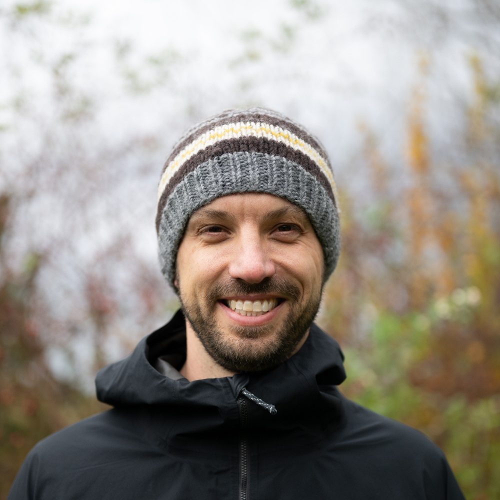 Man wearing Ambler Atlas handknit men's toque in heather grey with ribbed cuff.
