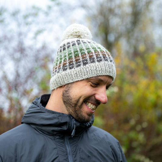 Man wearing Ambler Kori handknit wool toque in heather stone with checkered design.