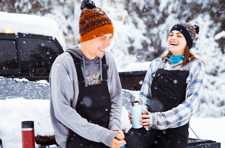 Couple drinking tea in winter, wearing Ambler toques