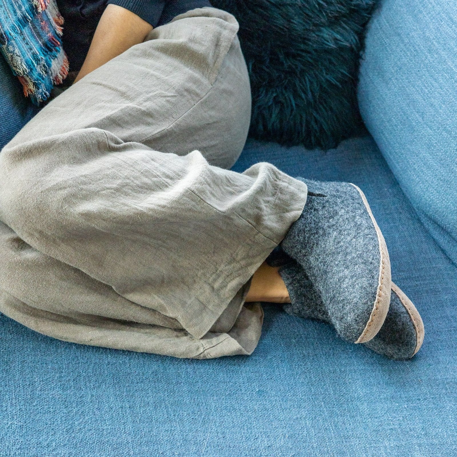Person wearing a pair of Ambler Carlyle wool felt slipper boots in heather charcoal. 