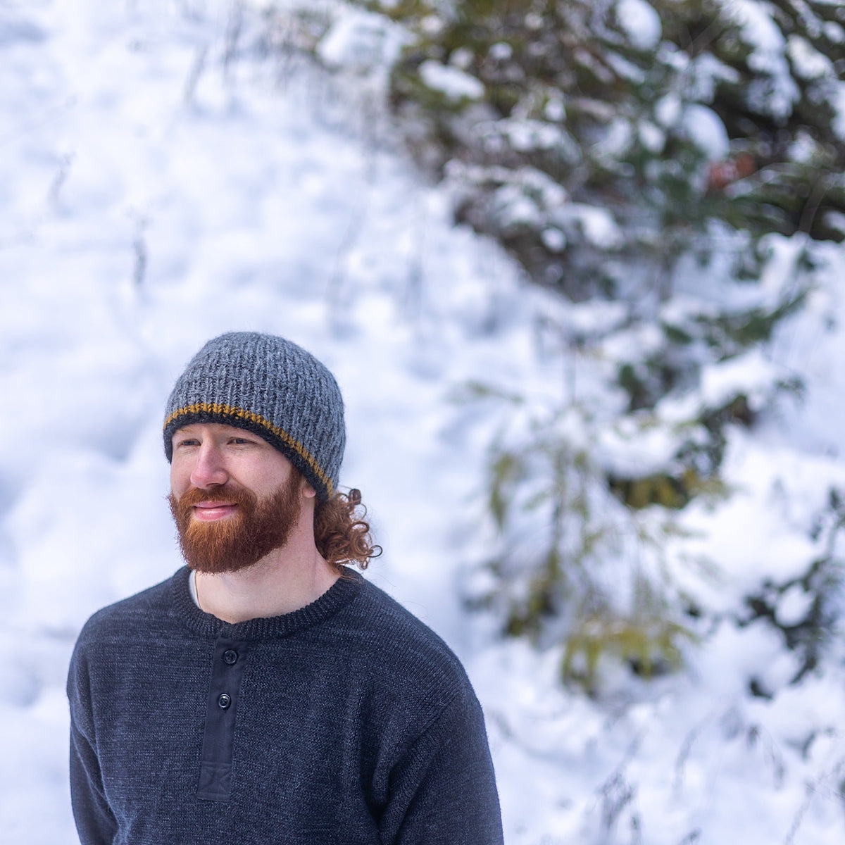 Man wearing Ambler Andrew handknit men&#39;s toque in heather grey. 