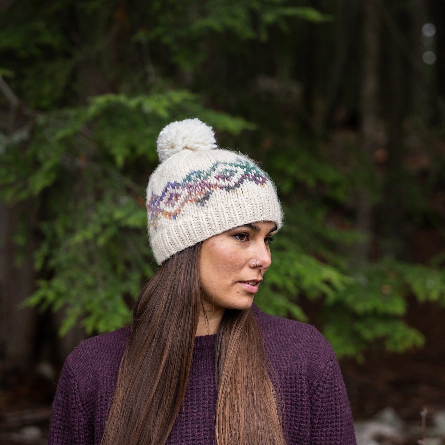 Woman wearing Ambler Anne handknit women's toque in natural with jacquard design and ribbed cuff. 