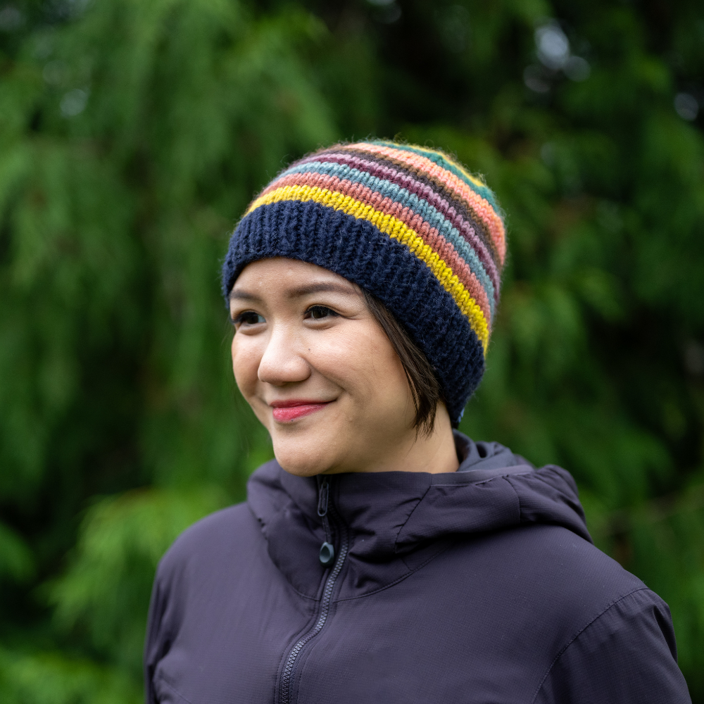 Woman wearing Ambler Fiesta handknit men's toque in midnight. 