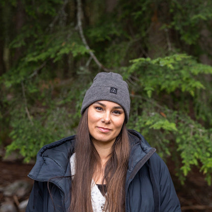 Woman wearing Made in Canada Ambler Frank machine knit toque with Ambler logo patch. 