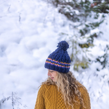 Woman wearing Ambler Parker handknit wool women's toque in navy - thick rib and medium pom. 