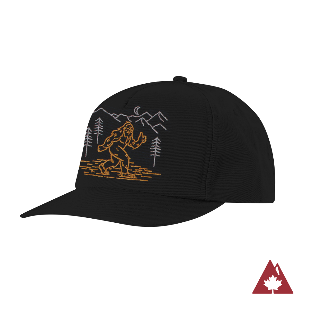 Black snapback cap with a graphic design of a sasquatch and mountains. 