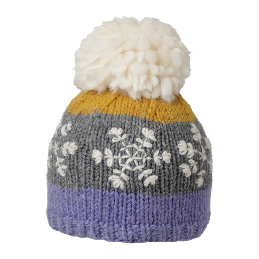 Ambler Snowflake handknit kids' toque in purple with embroidered snowflake design and medium pom. 