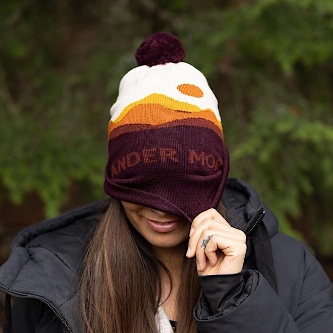Woman wearing Made in Canada Ambler Sunset machine knit toque in merlot. 